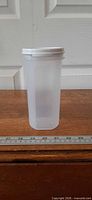 Front view of translucent 7 in spaghetti keeper with white lid