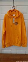 Front view of yellow hoodie on hanger