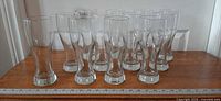 Front view of all 12 pilsner glasses lined on table
