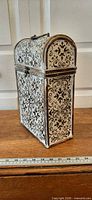 Front and side view of embossed wooden wine casket with ruler for scale