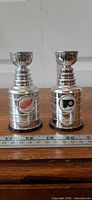 Both miniature Stanley Cups side by side with ruler