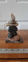 Front view of seven-stone cairn on marble base