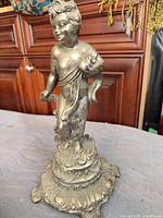 Front view of cherub figurine on ornate base