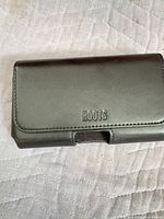 Front view showing embossed Roots logo on leather holster