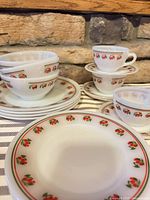 Stacked plates and bowls showing cherry motif and banding