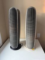Front view of both tower purifiers standing side by side
