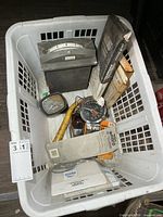 Top view of basket showing gauges, tune-up kit, tool, assorted boxes