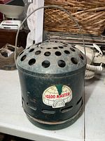 Front view showing full heater with handle and perforated top