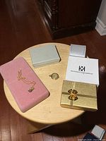 Overall view: necklace, vintage watch and four jewelry boxes on stool