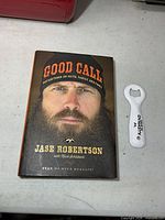 Front view of book and bottle opener side by side