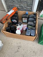 Overview of cardboard box showing multiple oil and stabilizer bottles