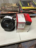 Black personal fan beside boxed Craftsman filter