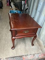 Top and side view of wooden end table showing finish and drawer front