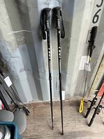 Full view of both LEKI Makalu hiking poles standing upright