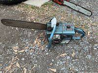 Left side view of Homelite XL-1 chainsaw showing full bar, chain, and body
