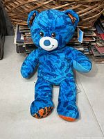 Front view of blue Hot Wheels Build-A-Bear plush with tag attached