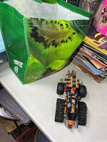 Bag of Lego bricks and partially built vehicle on table