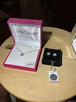 Necklace and earrings in boxes on table