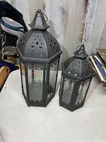 Both hexagonal metal and glass lanterns side by side
