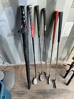 Full view of all five clubs and umbrella