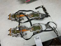 Both crampons laid flat showing overall design and tagging