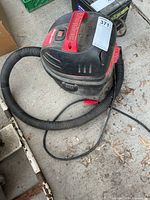 Angled view showing entire Shop-Vac with hose and cord