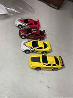 All four slot cars lined up on table