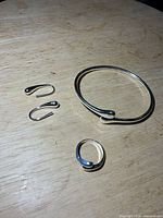 Full view of bracelet, ring and earrings on surface