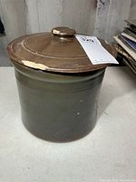 Crock with lid in place showing overall appearance and chips on lid edge
