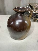 Front view of brown glazed stoneware jug