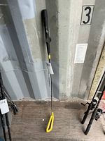Full view of Matzie training golf club standing upright showing entire length