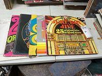 Five LP sleeves fanned out showing artwork including Jukebox Jive, large '20' sleeve and others
