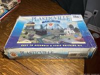 Front of sealed box displaying Bachmann Plasticville Covered Bridge kit artwork
