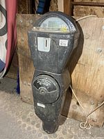 Front view of full parking meter showing coin slot, dial window, and vault door