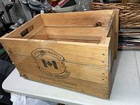 angled view of wood crate showing interior and side branding