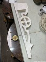 Full view of white wooden corbel on table