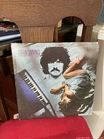 Front cover of Burton Cummings Dream of a Child LP leaning against chair