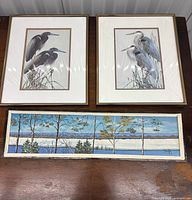 Front view of two heron prints and panoramic landscape painting