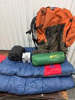Full lot showing backpack, sleeping bags, black bag, Spicer bag, stove box