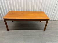 Full view of teak coffee table front and legs