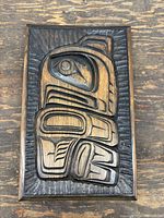 Front of first carved panel showing stylized Northwest Coast design