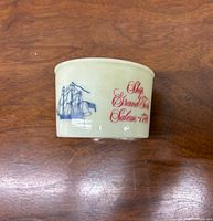 Side view showing sailing ship and red lettering on mug