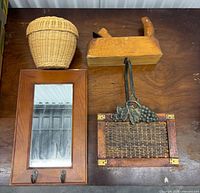 Group shot of all four items: mirror, basket, hand plane, trivet