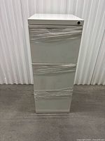 Front view showing three drawers, lock, overall condition