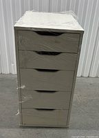 Front view of white 5-drawer chest wrapped in plastic