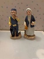 Front view of both signed ceramic figurines