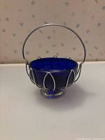 Front view showing cobalt glass bowl with silver filigree and handle