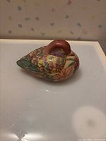 Left side view of multicolor porcelain bird figurine
