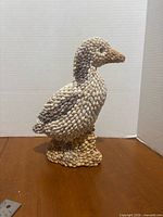 Full view of seashell duck figurine standing upright