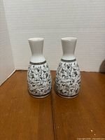 Front view showing both porcelain sake bottles